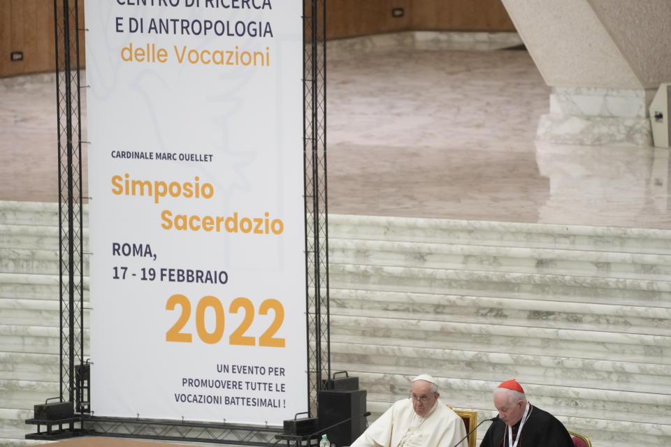 Pope Francis, left, listens to Cardinal Marc Ouellet's opening address as he attends the opening of a 3-day Symposium on Vocations in the Paul VI hall at the Vatican, Thursday, Feb. 17, 2022. (AP Photo/Gregorio Borgia)