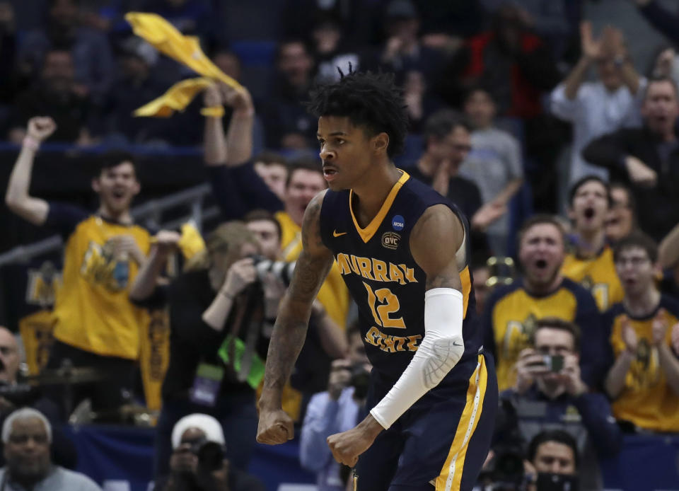 Fans cheer as Murray State's Ja Morant (12) celebrates a basket during the second half of a first round men's college basketball game against Marquette in the NCAA Tournament, Thursday, March 21, 2019, in Hartford, Conn. (AP Photo/Elise Amendola)