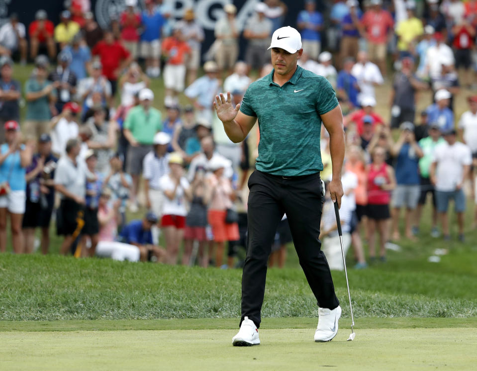Brooks Koepka waves to the crowd after making his birdie putt on the 15th hole during the final round of the PGA Championship golf tournament at Bellerive Country Club, Sunday, Aug. 12, 2018, in St. Louis. (AP Photo/Jeff Roberson)