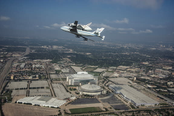 Space Shuttle Endeavour is ferried by NASA's Shuttle Carrier Aircraft (SCA) over Houston, Texas on September 19, 2012. NASA pilots Jeff Moultrie and Bill Rieke are at the controls of the Shuttle Carrier Aircraft. Photo taken by NASA photographe