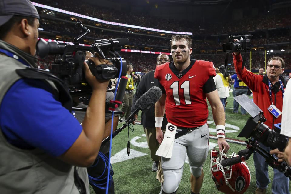 Georgia quarterback Jake Fromm (11) walks off the field after his team's loss to Alabama in an NCAA college football game for the Southeastern Conference championship Saturday, Dec. 1, 2018, in Atlanta. (AJ Reynolds/Athens Banner-Herald via AP)