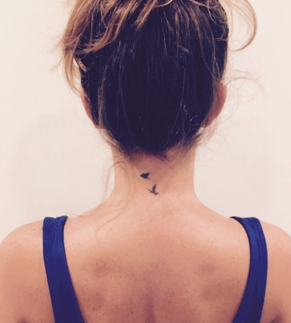 birds tattooed on someone's neck