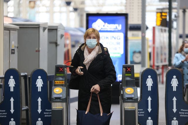 Passengers wearing masks travelling via Waterloo station in London (James Manning/PA)