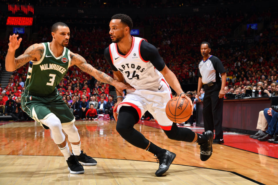 TORONTO, CANADA - MAY 21: Norman Powell #24 of the Toronto Raptors handles the ball against George Hill #3 of the Milwaukee Bucks during Game Four of the Eastern Conference Finals of the 2019 NBA Playoffs on May 19, 2019 at the Scotiabank Arena in Toronto, Ontario, Canada.  NOTE TO USER: User expressly acknowledges and agrees that, by downloading and or using this Photograph, user is consenting to the terms and conditions of the Getty Images License Agreement.  Mandatory Copyright Notice: Copyright 2019 NBAE (Photo by Jesse D. Garrabrant/NBAE via Getty Images)