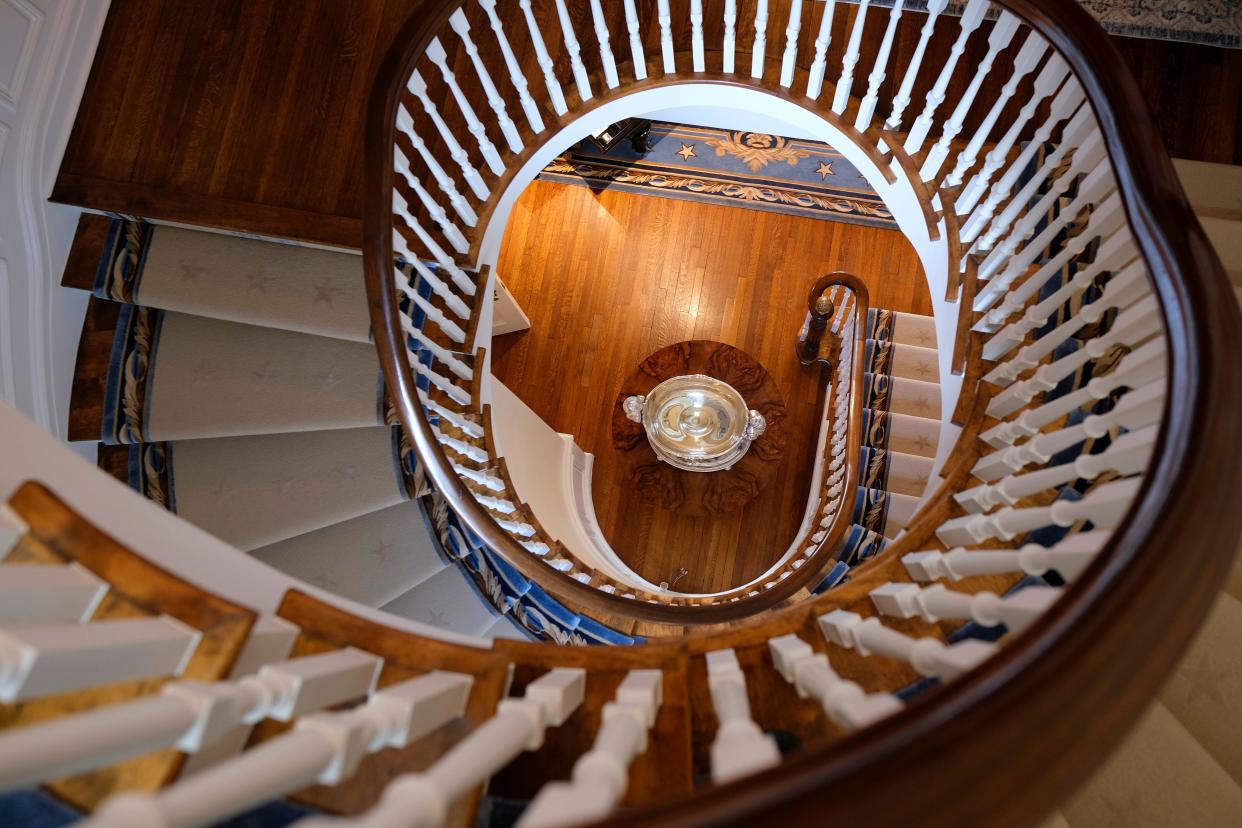 During a tour of the Oklahoma Governor's Mansion in January 2023, the U.S.S. Oklahoma punch bowl replica could be seen from the spiral staircase.
