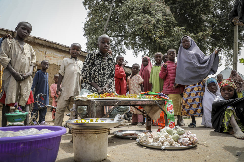 Children play and sell small foodstuffs on the street in the town of Jangebe, Nigeria, where more than 300 girls were abducted by gunmen on Friday from the the Government Girls Junior Secondary School, in Zamfara state, northern Nigeria Saturday, Feb. 27, 2021. Nigerian police and the military have begun joint operations to rescue the more than 300 girls who were kidnapped from the boarding school, according to a police spokesman. (AP Photo/Ibrahim Mansur)