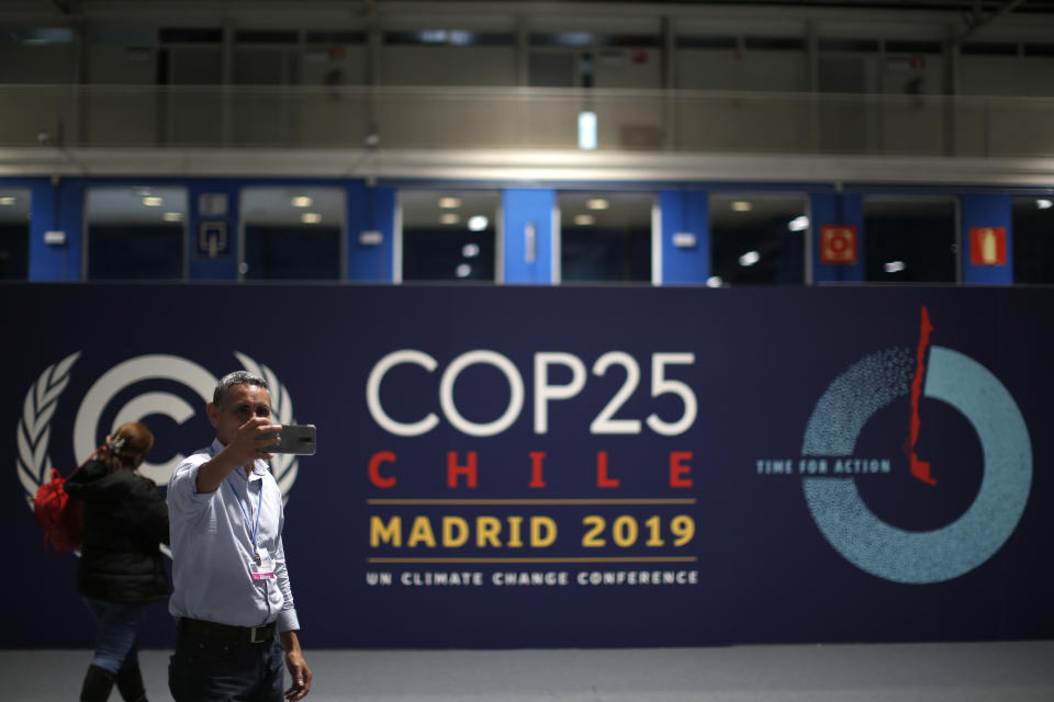 A participant takes a selfie ahead of the Climate Summit COP25 in Madrid, Spain, Friday, Nov. 29, 2019. The Climate Summit COP25 runs between 2 Dec. until 13 Dec in Madrid. (AP Photo/Manu Fernandez)