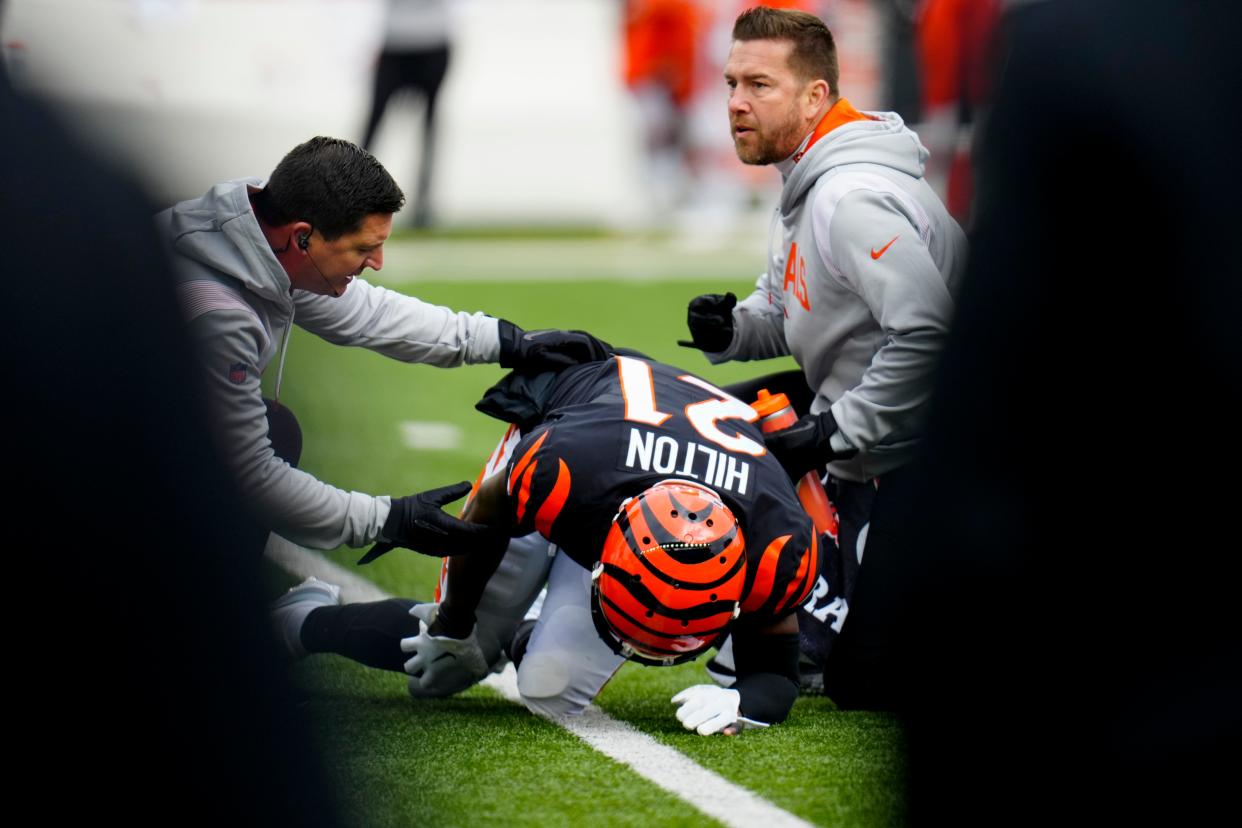 Cincinnati Bengals cornerback Mike Hilton is assisted by the training staff.