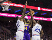 Los Angeles Lakers' Brandon Ingram, center, goes up for the shot against Philadelphia 76ers' Joel Embiid, left, of Cameroon, and Jimmy Butler, right, during the first half of an NBA basketball game, Sunday, Feb. 10, 2019, in Philadelphia. (AP Photo/Chris Szagola)