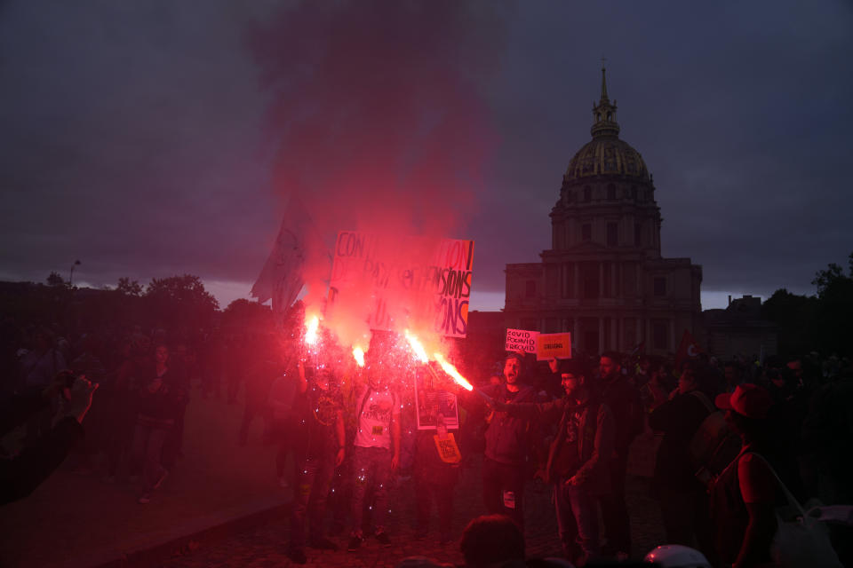 FILE - Protestors hold flares during a demonstration for salary raise, in Paris, Oct. 18, 2022. Across Europe, soaring inflation is behind a wave of protests and strikes that underscores growing discontent with spiralling living costs and threatens to unleash political turmoil. (AP Photo/Francois Mori, file)