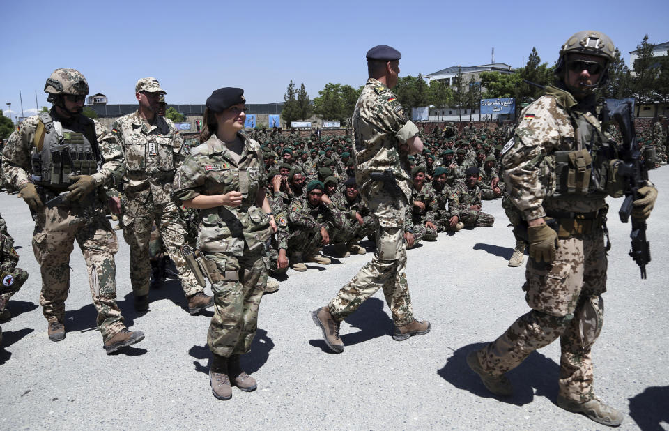 FILE- In this Monday, May 27, 2019 file photo, NATO forces attend the graduation ceremony of Afghan National Army soldiers from a 3-month training program at the Afghan Military Academy in Kabul, Afghanistan. (AP Photo/Rahmat Gul, File)