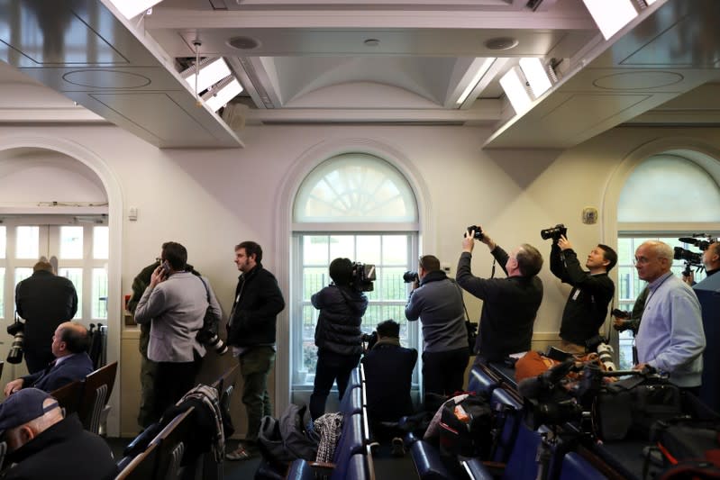 Reporters crowd the windows of the White House during a lockdown because of reports of a stray airplane over Washington