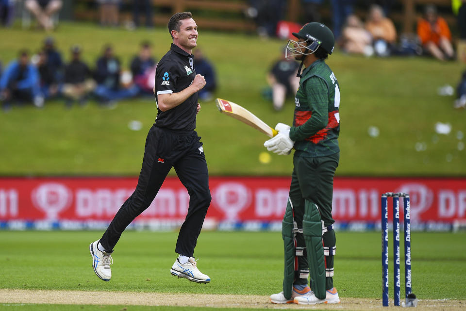 New Zealand's Adam Milne, left, celebrates after taking the wicket of Bangladesh's Soumya Sarkar, right, during the first One Day cricket international between New Zealand and Bangladesh at University Oval in Dunedin, New Zealand, Sunday, Dec. 17, 2023. (Chris Symes/Photosport via AP)