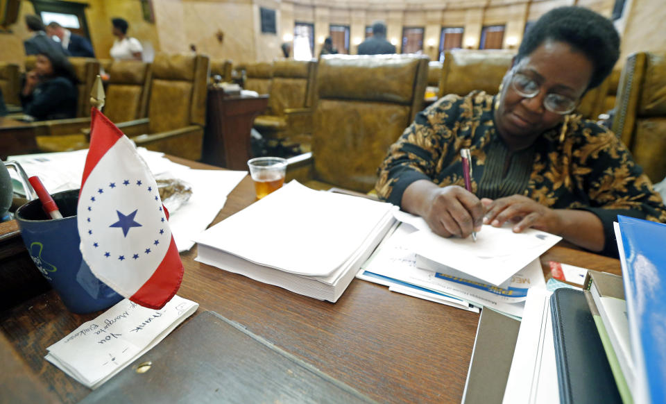 FILE- In this Feb. 17, 2016 file photo, a new conceptualized Mississippi state flag sits on the desk of Rep. Kathy Sykes, D-Jackson, at the Capitol in Jackson, Miss. The flag was designed by Laurin Stennis, the granddaughter of the late U.S. Sen. John Stennis, D-Miss. Mississippi residents who want a state flag without the Confederate battle emblem now have an alternative at least for their license plates. Gov. Phil Bryant on Tuesday, April 17, 2019, signed a bill authorizing designs for several new specialty license plates (AP Photo/Rogelio V. Solis, File)