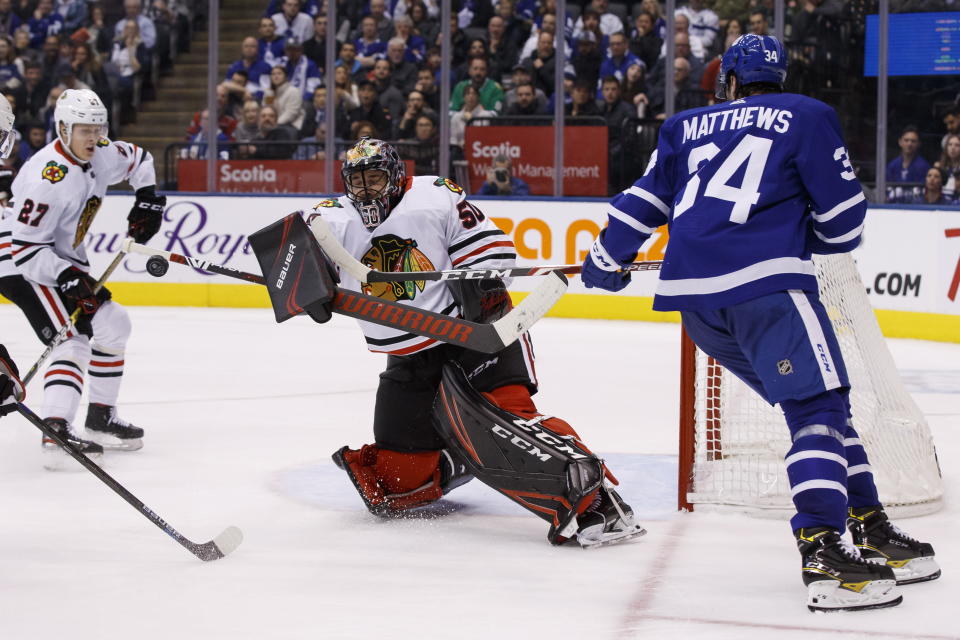 Chicago Blackhawks goaltender Corey Crawford (50) stops Toronto Maple Leafs centre Auston Matthews (34) during second period NHL hockey action in Toronto, Saturday, Jan. 18, 2020. (Cole Burston/The Canadian Press via AP)