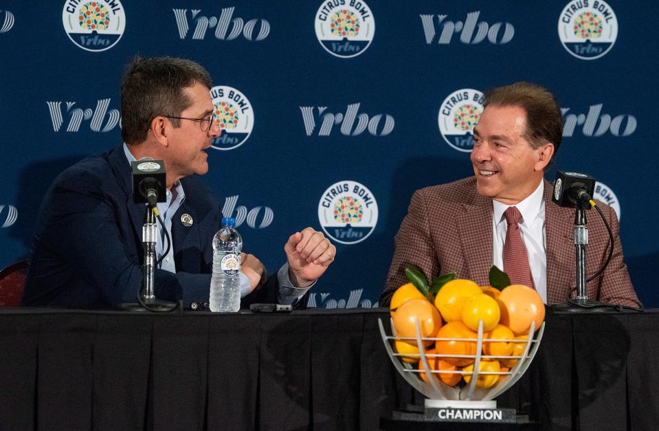 Michigan coach Jim Harbaugh (left) and Alabama coach Nick Saban probably won't be cracking jokes before their CFP semifinal game, like they did here before meeting in the 2019 Citrus Bowl.