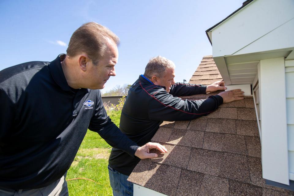 Bill and Drew Cowley, brothers and co-owners of Cowleys Pest Services, an over 30-year-old Howell-based provider of pest control services, demonstrate an animal proofing solution after a wildlife damage repair at their business on Route 33 in Howell, NJ Monday, May 9, 2022.