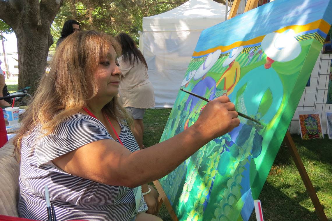 Consuelo Soto Murphy paints during Richland’s Art in the Park last year.