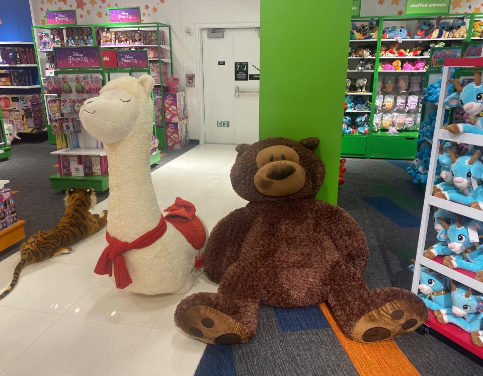 Giant stuffed animal llama and brown bear.