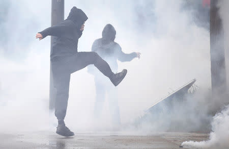 A protester reacts to tear gas canisters fired by police at a demonstration during the Act XXIV (the 24th consecutive national protest on Saturday) of the yellow vests movement in Strasbourg, France, April 27, 2019. REUTERS/Vincent Kessler