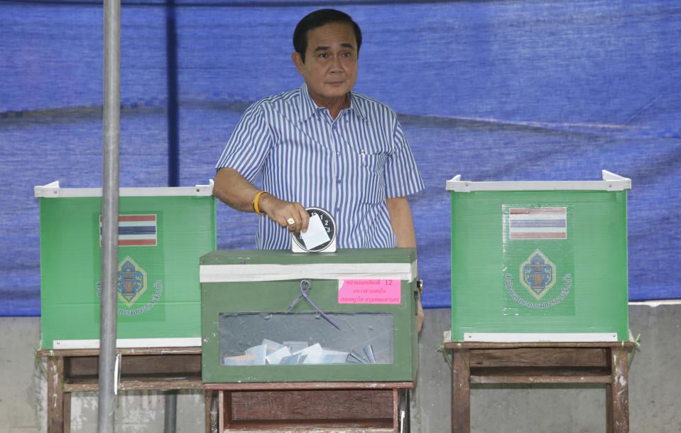 In this Sunday, Aug. 7, 2016, photo, Thai Prime Minister Prayuth Chan-ocha pauses as he casts his vote in a referendum on a new constitution at a polling station in Bangkok, Thailand. Prayuth became prime minister in a very Thai way: He led a military coup. Now after five years of running Thailand with absolute power, he’s seeking to hold on to the top job through the ballot box. (AP Photo/Sakchai Lalit)