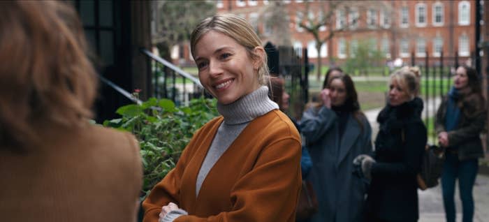 Sienna Miller smiles at someone