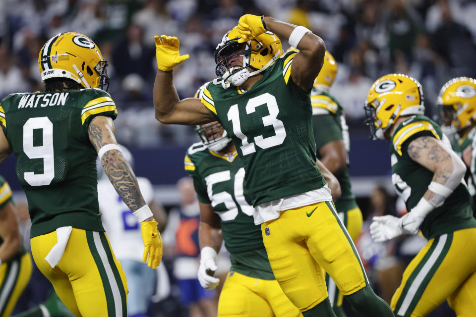 Green Bay Packers wide receiver Dontayvion Wicks (13) celebrates with wide receiver Christian Watson (9) after scoring on a touchdown catch against the Dallas Cowboys during the first half of an NFL football game, Sunday, Jan. 14, 2024, in Arlington, Texas. (AP Photo/Michael Ainsworth)