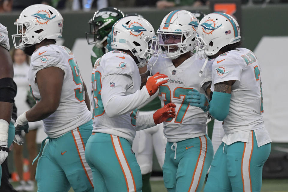 Miami Dolphins' Myles Gaskin, second from right, celebrates his touchdown during the second half of an NFL football game against the New York Jets, Sunday, Nov. 21, 2021, in East Rutherford, N.J. (AP Photo/Bill Kostroun)