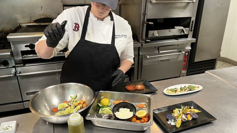 The produce grown at Fenway Farms stays as local as it gets -- used in the kitchens at the baseball stadium to serve fans. Here, executive sous chef Danielle Morgan prepares a fresh salad using ingredients harvested from the farm. - Samantha Bresnahan/CNN
