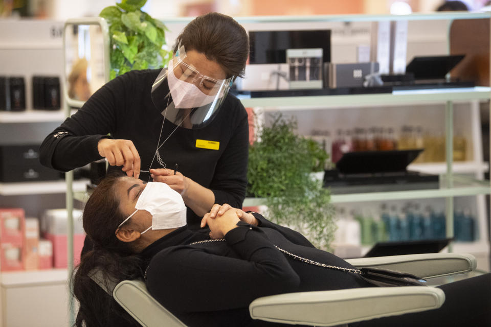 <p>A woman has her eyebrows threaded at Selfridges department store on Oxford Street, London on the first day of its reopening as England takes another step back towards normality with the further easing of lockdown restrictions. Picture date: Monday April 12, 2021.</p>
