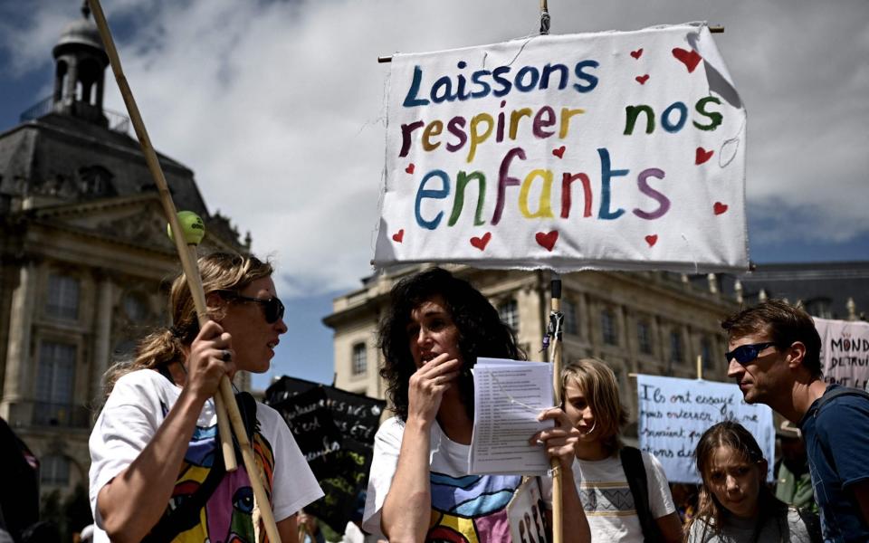 Demonstrators hold up banners and placards, during a national day of protest against the compulsory Covid-19 vaccination for certain workers  - PHILIPPE LOPEZ/AFP