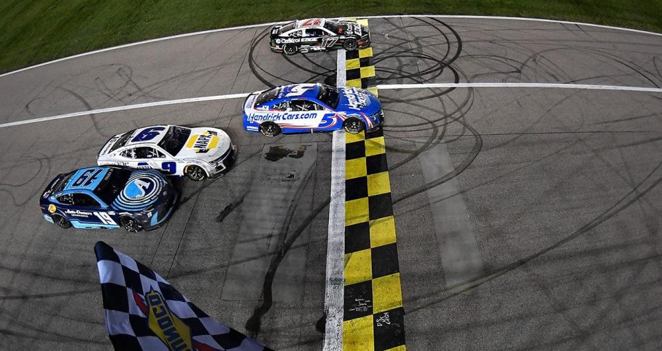 Cars race to the finish at Kansas.