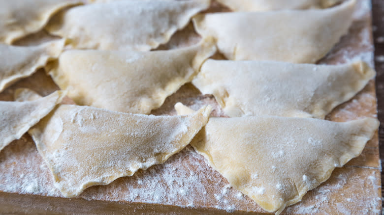 Floured triangular kreplach dumplings