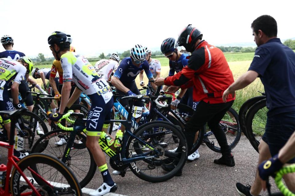 Riders check their bike after a crash in the pack during the third stage of the 75th edition of the Criterium du Dauphine cycling race 1945 kms between MonistrolSurLoire and Le Coteau centraleastern France on June 6 2023 Photo by AnneChristine POUJOULAT  AFP Photo by ANNECHRISTINE POUJOULATAFP via Getty Images