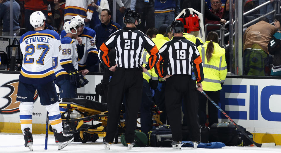 The St. Louis Blues watch as paramedics tend to teammate Jay Bouwmeester after he collapsed on the bench during an NHL regular season game in February. (Photo by Debora Robinson/NHLI via Getty Images)