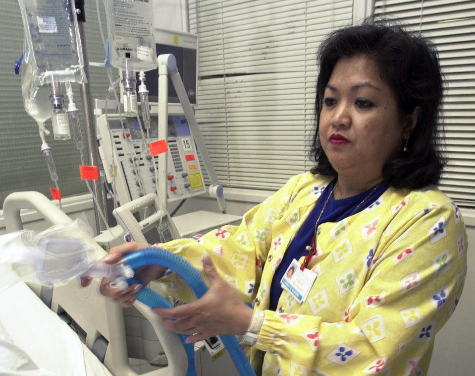 Lovely R. Suanino, a respiratory therapist at Newark Beth Israel Medical Center in Newark, N.J., demonstrates setting up a ventilator in the Intensive Care Unit of the hospital. (AP Photo/Mike Derer)