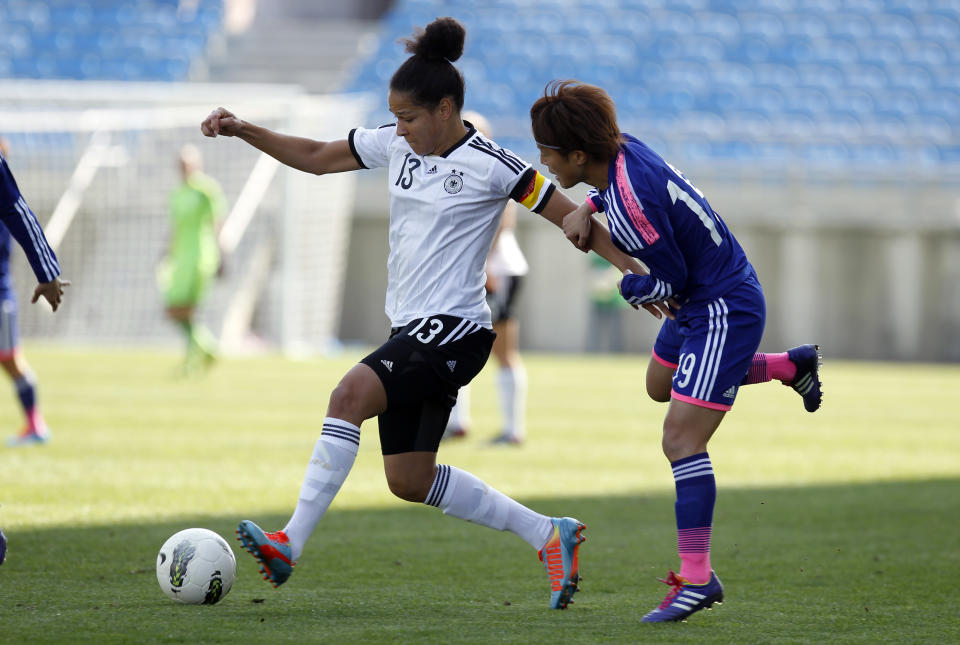 Germany's Celia Sasic, left, battles for the ball with Japan's Ariyoshi Saori during the women's soccer Algarve Cup final match between Germany and Japan at the Algarve stadium, outside Faro, southern Portugal, Wednesday, March 12, 2014. (AP Photo/Francisco Seco)