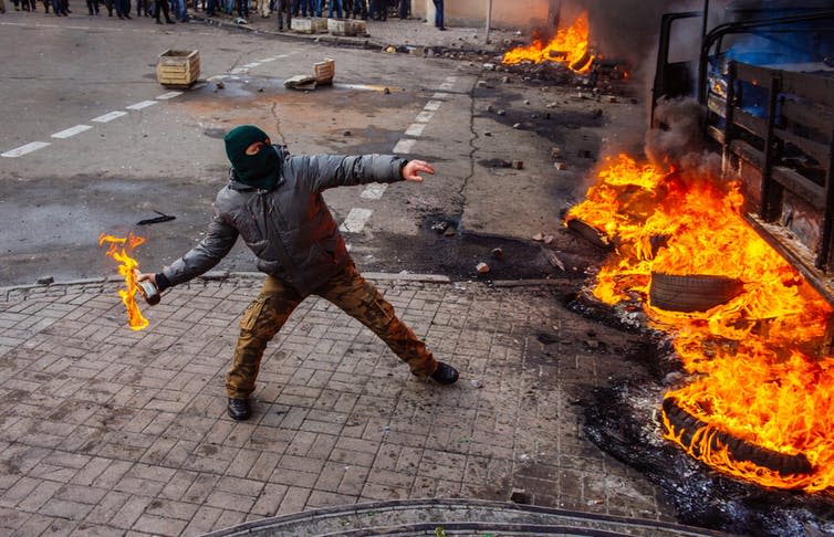 <span class="caption">A street protestor in Kyiv, Ukraine.</span> <span class="attribution"><a class="link " href="https://www.shutterstock.com/image-photo/street-protests-kiev-revolution-263735459?src=c4bad0b2-2a16-4f52-8789-2bfb35912567-1-1" rel="nofollow noopener" target="_blank" data-ylk="slk:Shutterstock;elm:context_link;itc:0;sec:content-canvas">Shutterstock</a></span>