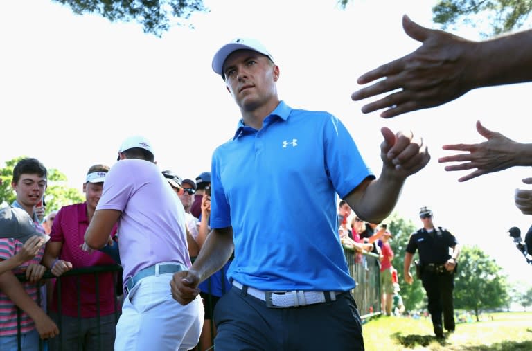 Jordan Spieth of the US high-fives fans after putting on the ninth green during the first round of the Travelers Championship, at TPC River Highlands in Cromwell, Connecticut, on June 22, 2017