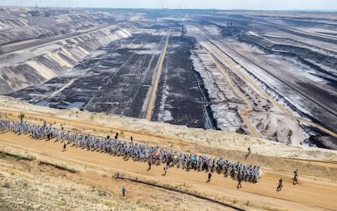 Climate activists walk on a driveway after entering the grounds of the Garzweiler brown coal mine in Garzweiler, western Germany, - Credit: DPA