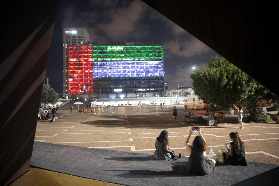 FILE - In this Thursday, Aug. 13, 2020 file photo, the Tel Aviv City Hall is lit up with the flag of the United Arab Emirates as Israel and the UAE announced they would be establishing full diplomatic ties, in Tel Aviv, Israel. For eager Israelis, anticipation is mounting that Dubai’s glitzy Burj Khalifa, will soon join the ranks of the Pyramids in Egypt and relics of the ancient Nabatean Kingdom of Petra in Jordan as an iconic landmark that was once unattainable but is now within reach. Last week’s dramatic announcement made the UAE just the third Arab nation to establish full diplomatic ties with Israel. (AP Photo/Oded Balilty, File)
