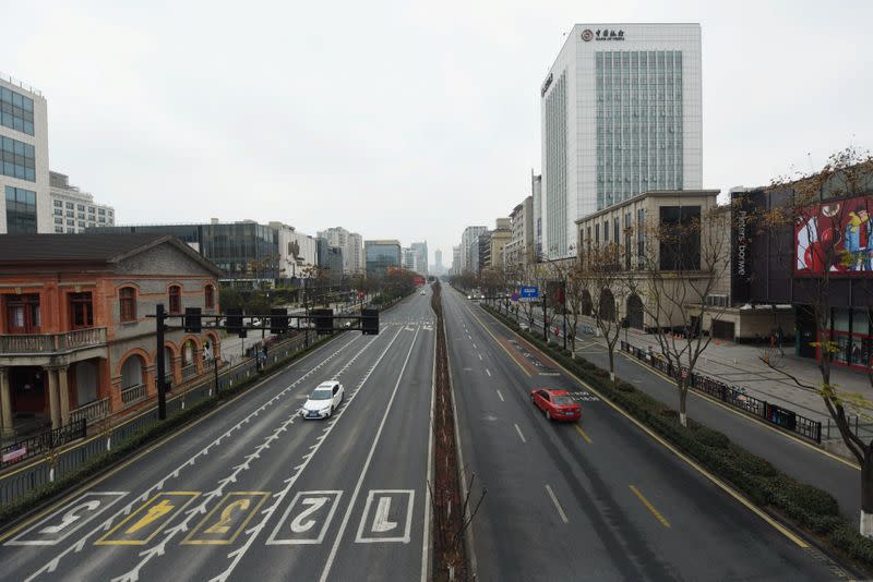 Cars travel on Yanan Road, a main commercial area in Hangzhou, after the city imposed new measures to prevent and control the new coronavirus