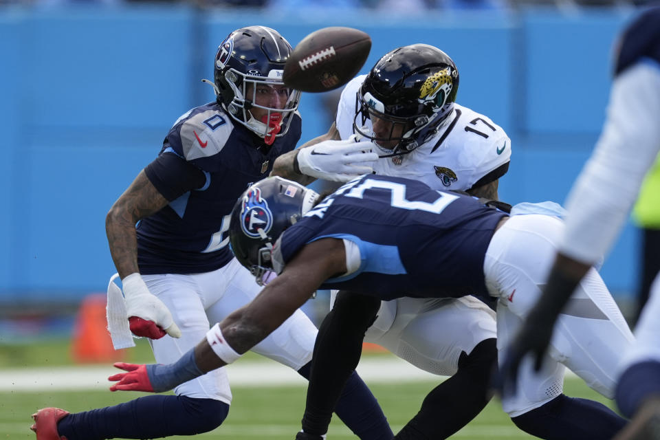 Tennessee Titans linebacker Azeez Al-Shaair (2) breaks up a pass intended for Jacksonville Jaguars tight end Evan Engram (17) during the first half of an NFL football game Sunday, Jan. 7, 2024, in Nashville, Tenn. (AP Photo/George Walker IV)