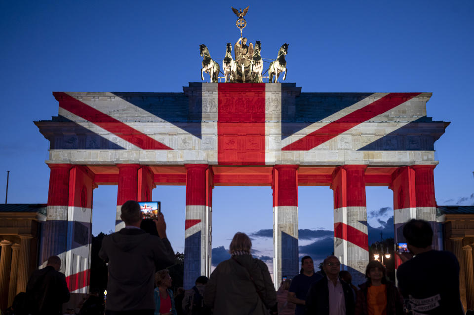 The Brandenburg Gate is illuminated in the colors of the Union Jack to mark the passing of Queen Elizabeth II, in Berlin, Germany, Friday Sept. 9, 2022. (Fabian Sommer/dpa via AP)