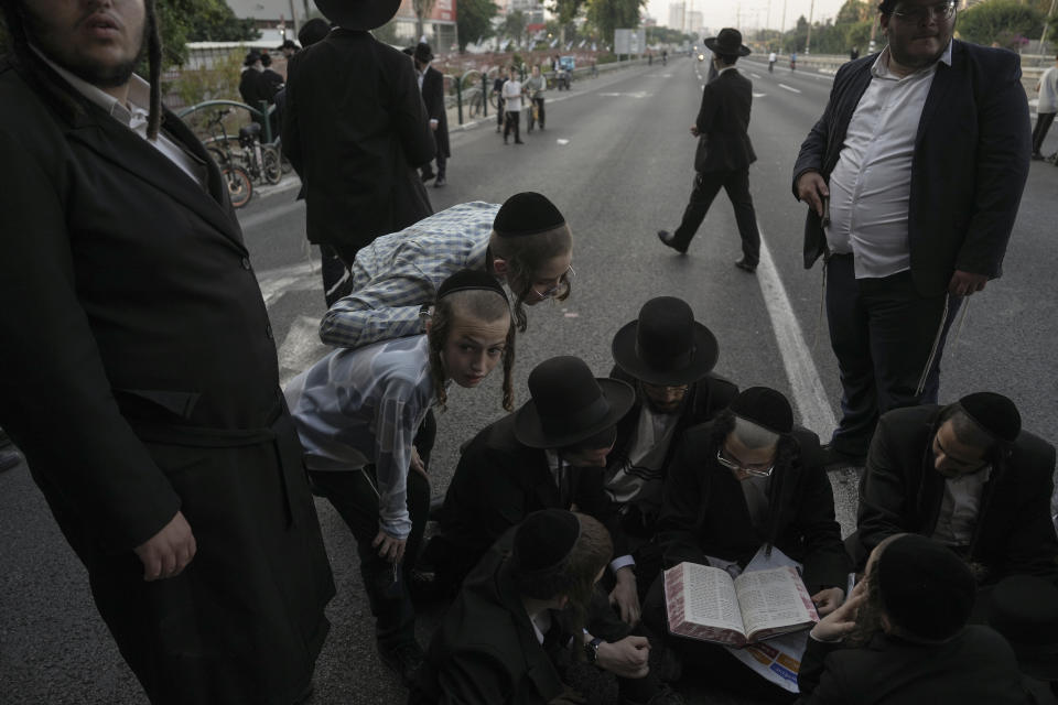 Ultra-Orthodox Jews block a highway during a protest against army recruitment in Bnei Brak, Israel, Thursday, June 27, 2024. Israel's Supreme Court unanimously ordered the government to begin drafting ultra-Orthodox Jewish men into the army — a landmark ruling seeking to end a system that has allowed them to avoid enlistment into compulsory military service. (AP Photo/Oded Balilty)