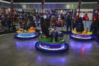 Bumper cars that spin and display flashing lights were part of the items on display at the International Association of Amusement Parks and Attractions convention Tuesday, Nov. 19, 2019, in Orlando, Fla. (AP Photo/John Raoux)