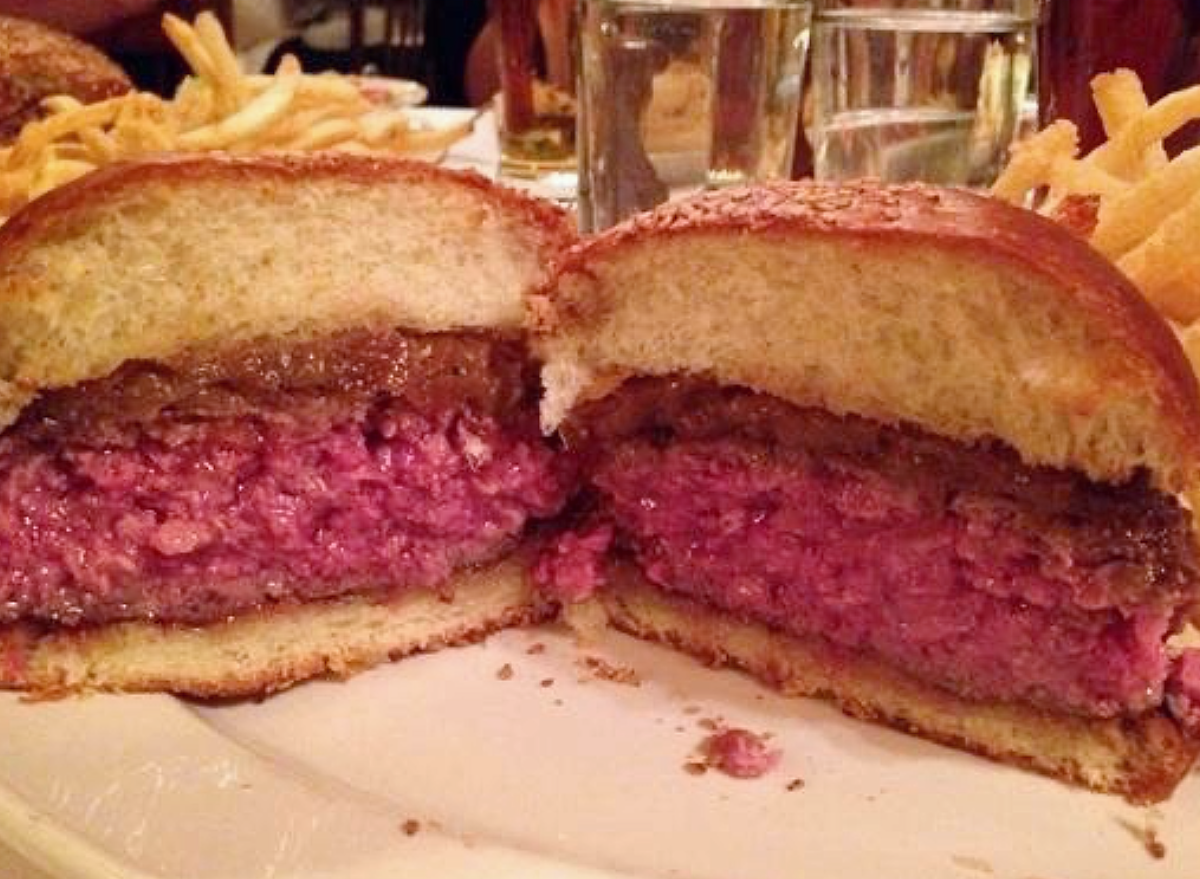 a burger from minetta tavern cut open.