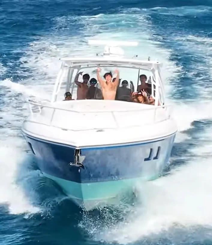 Boca Bash party goers wave to the drone camera after dumping garbage in the Atlantic.