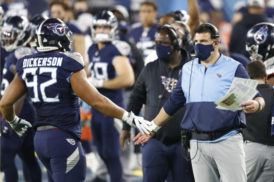 Tennessee Titans head coach Mike Vrabel slaps hands with defensive end Matt Dickerson (92) after a play against the Buffalo Bills in the first half of an NFL football game Tuesday, Oct. 13, 2020, in Nashville, Tenn. (AP Photo/Wade Payne)