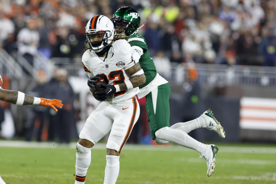 Cleveland Browns safety Ronnie Hickman intercept a pass for a touchdown intended for New York Jets wide receiver Garrett Wilson during the first half of an NFL football game Thursday, Dec. 28, 2023, in Cleveland. (AP Photo/Ron Schwane)